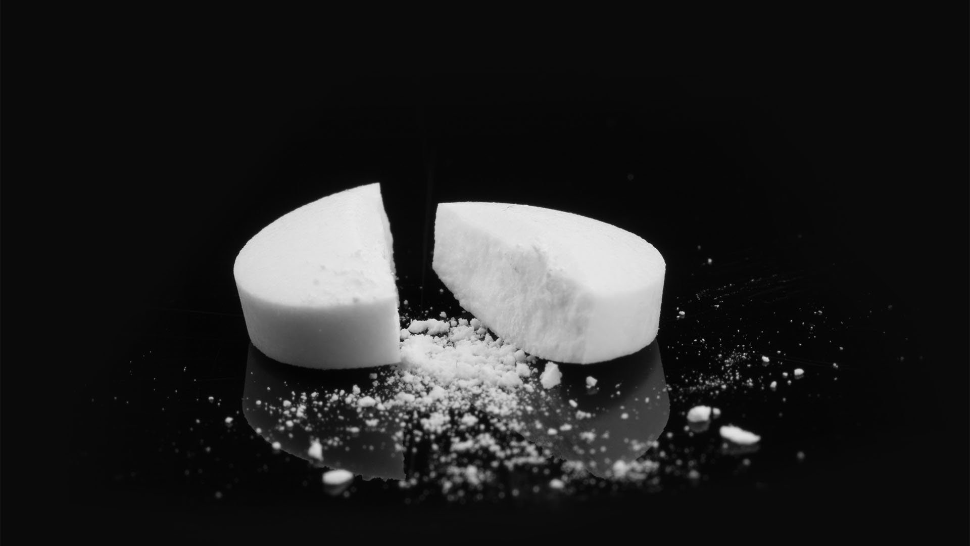 A photo of a white broken pill.