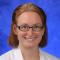 Headshot of Lauren Jodi Van Scoy, MD with medium brown hair in glasses and white doctor's coat.
